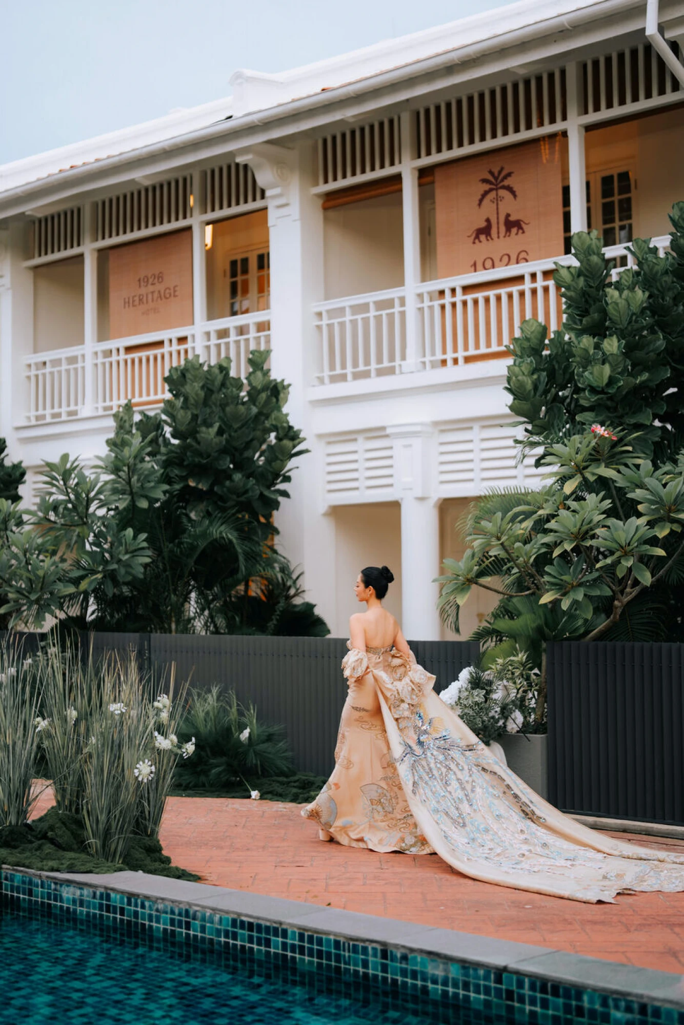 Bridal gown by the pool framed by heritage architecture at 1926 Heritage Hotel Penang